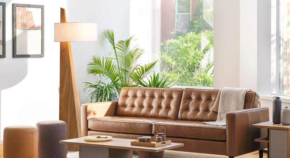 Floor lamp with wood base providing ambient lighting in modern living room